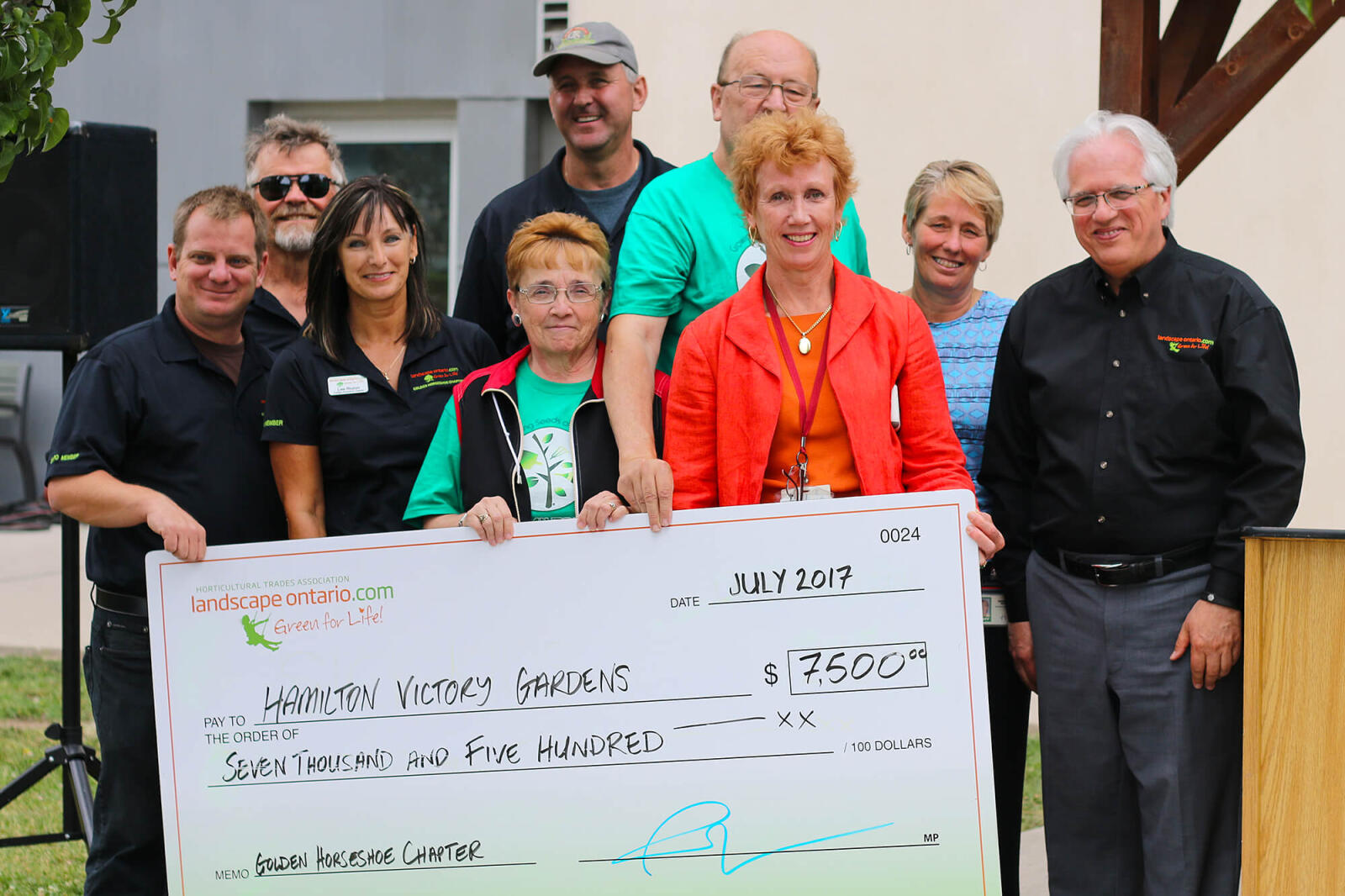 group holding a cheque donation